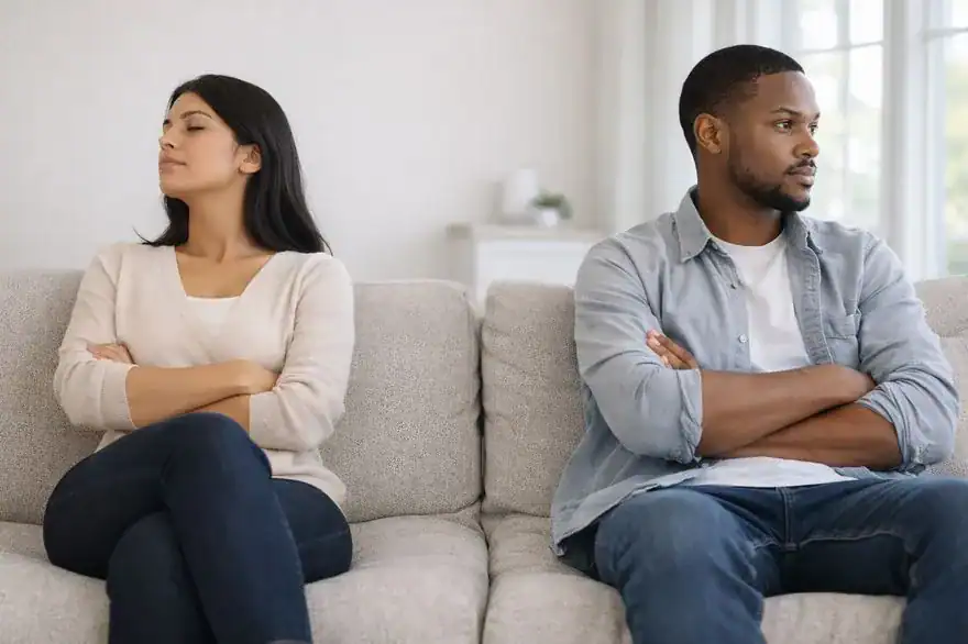 Couple thinking about divorce on ends of the sofa